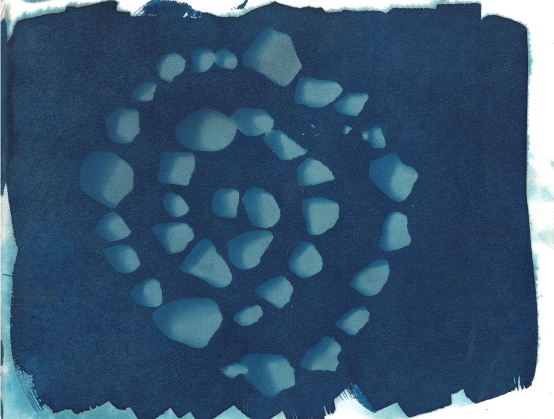 hornby cyanotype 2025; a spiral of rocks shadowing a blue background